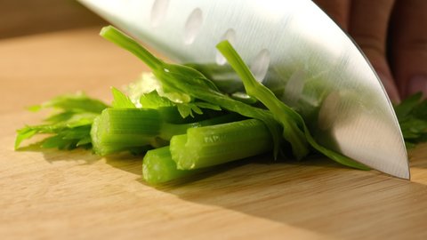 Closeup view of parsley chopped in a wooden chopping board , for plants and vegetables advertising