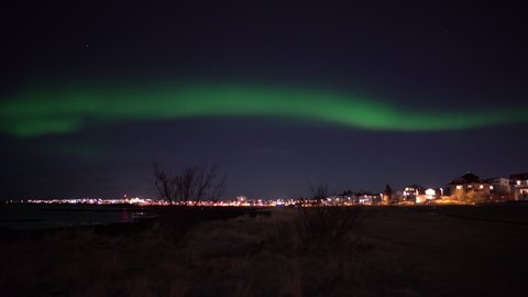 Aurora borealis over Reykjavik Iceland shore realtime
