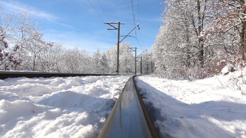 Railway and winter landscape. Railroad by forest at winter.