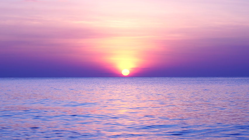 Landscape sunset or sunrise light  nature cloudscape sky.Red purple orange blue pink sunsets over sea. Burning sky shining golden waves. Sun over sea silhouette paradise island. Color Violet purple.