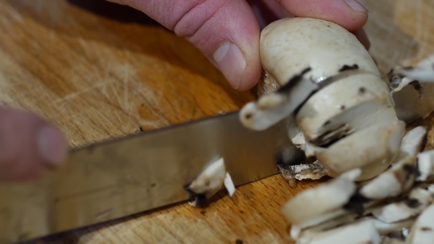 A french cook cutting mushrooms to make a tasty vegan dish