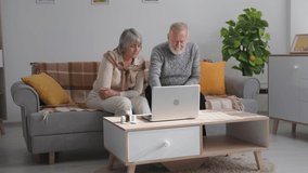 doctor online, an elderly woman and a man in poor health communicate with a therapist via video link on a laptop while sitting at home due to quarantine