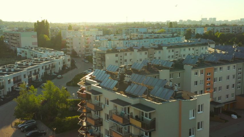 Aerial view of solar panel modules on the roofs of modern residential buildings in a European city. solar panels installed on the roofs of buildings, renewable energy, ecology, photovoltaic solar  Royalty-Free Stock Footage #1083990742