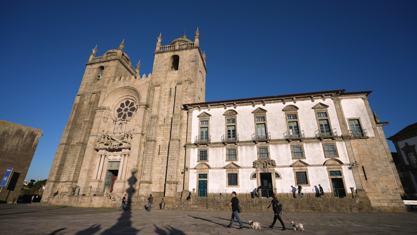 Porto, Portugal, 2021: View of European cathedral - Se do Porto. Travelers and tourists walking around building. Portuguese religious sights. Tourism traveling to catholic fate landmarks in Europe. Royalty-Free Stock Footage #1083993388