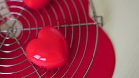 Glazed cakes in the shape of hearts lie on a metal stand on the table - Powered by Shutterstock - Get 15% off with code: PIKWIZARD15