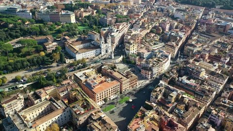 Aerial drone video of iconic Piazza di Spagna and beautiful baroque stairway a popular meeting place, Rome, Italy