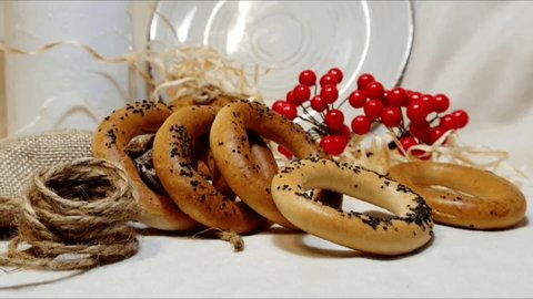 Beautiful bagels with poppy seeds on the table. Delicious bagels for tea. Bagels background. Sweets on the table.
