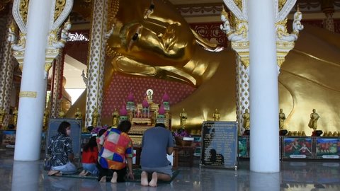 Thai people and foreign travelers travel visit respect praying and rite ritual blessing from reclining buddha at Wat Rat Prakhong Tham temple of Nonthaburi on November 28, 2021 in Bangkok, Thailand