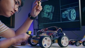 Asian teenager doing Arduino robot homework project in house, technology of robotics programing and kids education concept. - Powered by Shutterstock - Get 15% off with code: PIKWIZARD15