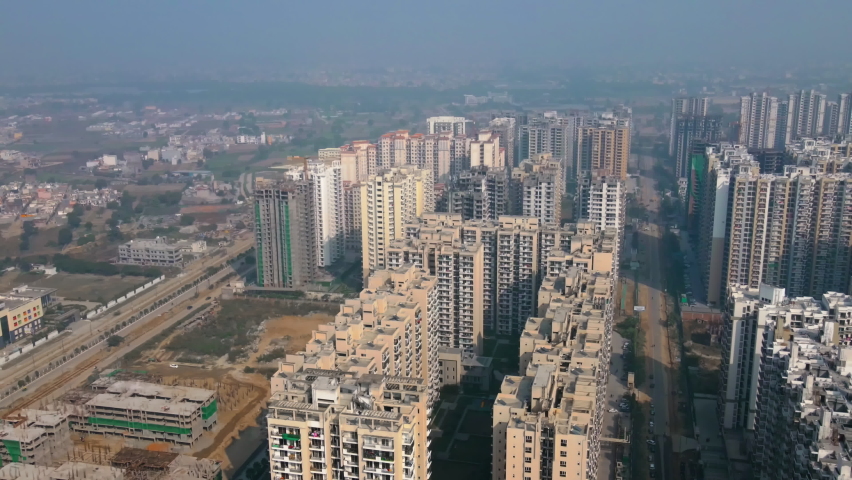 Aerial view of Greater Noida City in Uttar Pradesh, India. Construction of a multi-story Residence apartment building. Drone shot of modern City high-rise skyscraper buildings in India.
