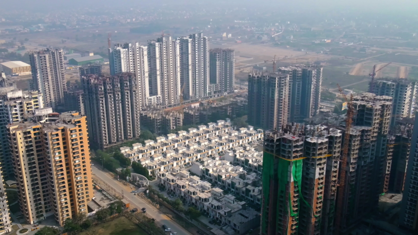 Aerial view of Greater Noida City in Uttar Pradesh, India. Construction of a multi-story Residence apartment building. Drone shot of modern City high-rise skyscraper buildings in India.