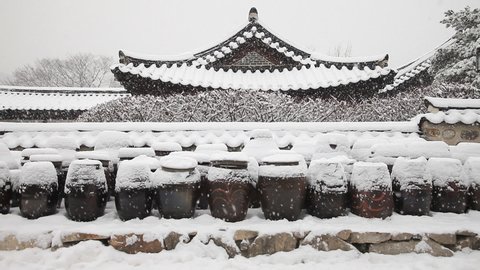 Hanok (korean traditional house) and Jangdokdae (korean traditional platform for crocks of sauces and condiments) in the winter snow