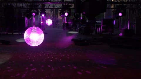 lights hitting disco ball at concert venue