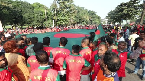 Dhaka, Bangladesh - December 13, 2021: On the occasion of the golden jubilee of Bangladesh's independence, the Bangladeshi people rallied with the national flag in front of the parliament building.