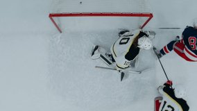 OVERHEAD HIGH ANGLE Player scoring a goal during the hockey game. Shot with 2x anamorphic lens - Powered by Shutterstock - Get 15% off with code: PIKWIZARD15