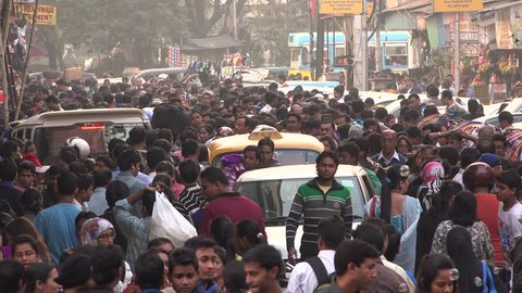 KOLKATA, INDIA - 13 DECEMBER 2014: Large numbers of people walk through a busy shopping street and popular market in central Kolkata, one of India's largest cities.