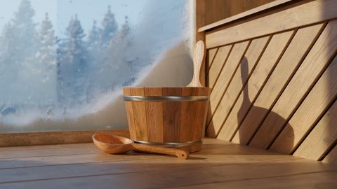 Wooden sauna bucket on the floor with a cold blue winter forest behind frosty window. Big snowflakes falling slowly from the sky covering lush coniferous trees. The contrast of temperature and climat