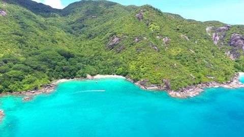 Drone clip at Anse Major beach on Mahe with turquoise blue water and palm trees in the Seychelles 