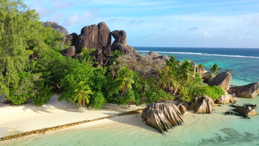 Drone clip on the beautiful island of La Digue in the Seychelles on the dream beach of Anse Source d'Argent  Royalty-Free Stock Footage #1084045168