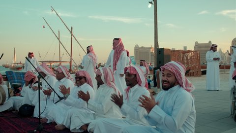 Doha, Qatar - December 7 2021: Katara eleventh traditional dhow festival in Doha Qatar sunset shot showing Qatar traditional folklore dance (Ardah dance) 