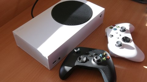 December 9, 2021 - Kehl, Germany: Two joysticks in black and white on the table in front of the game console White Microsoft Xbox Series S Game Controller, The newest wireless gamepad, joysticks for