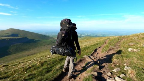 High Cup Nick. Cumbria. England. June. 2. 2021. Backpacker hiking The Pennine Way walking forward away from the camera