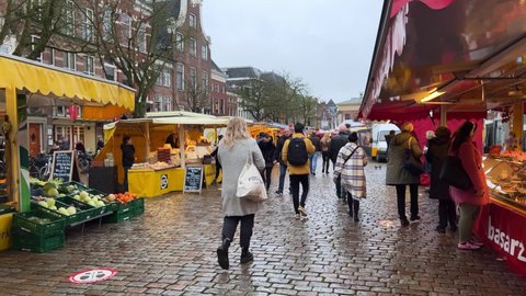 GRONINGEN, NETHERLANDS - 17. DECEMBER 2021: Walking shot of Fish market square in the student city of Groningen during winter