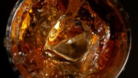 Super Slow Motion Detail Shot of Pouring Whiskey on Ice Cubes into Glass at 1000fps. - Powered by Shutterstock - Get 15% off with code: PIKWIZARD15