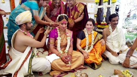 Bangalore, Karnataka, India-November 17 2021;The sacred ritual of Haldi and Mangal sutra event in a Hindu wedding of a South Indian couple in their traditional dress in Bangalore, India.
