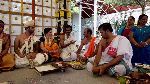 Bangalore, Karnataka, India-November 17 2021; A Clip of an Hindu Wedding ritual featuring the Bride, Groom, Priests and the family members in their traditional South Indian costume, in India.
