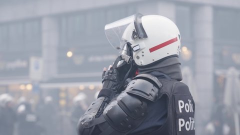 Brussels , Belgium - 12 05 2021: Policeman Wearing Gas Mask Against Tear Gas Smoke