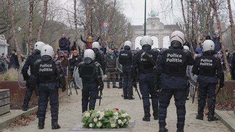 Brussels , Belgium - 12 05 2021: Group of social activists protesting in front of riot police officers in the Belgian capital