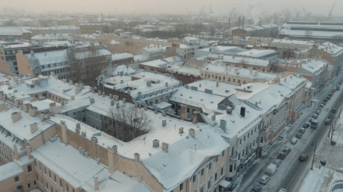 Russia, St. Petersburg, 07 December 2021: Slow motion footage of winter view of St. Petersburg at snow storm, frozen Neva river, huge ship, Isaac cathedral, car traffic on Blagoveshenskiy bridge