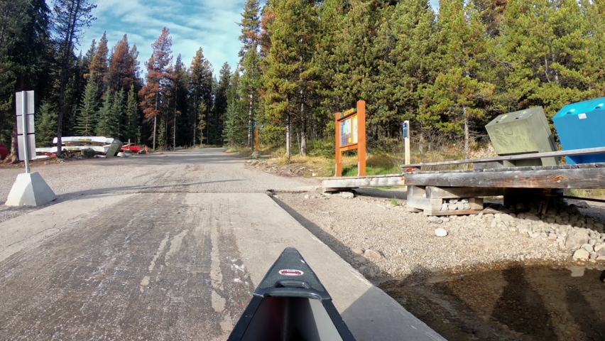 Canoeing out of pier in autumn pine forest on sunny at Maligne lake, Jasper national park, Canada