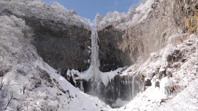 Waterfall Kegon with snowy basalt wall, Japan. Almost frozen waterfall. Kegon fall in winter. 4K High quality footage. Snow everywhere. - Powered by Shutterstock - Get 15% off with code: PIKWIZARD15