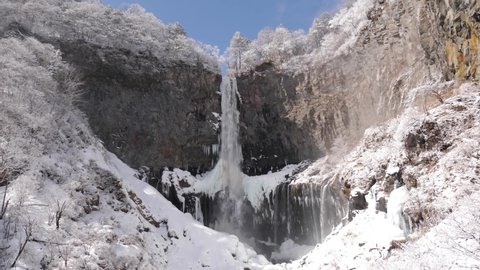 Waterfall Kegon with snowy basalt wall, Japan. Almost frozen waterfall. Kegon fall in winter. 4K High quality footage. Snow everywhere.