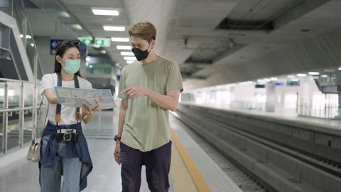 Couple traveler with bag, luggage, arrival  traveling, travel, trip for woman concept, Trip in summer with face mask for protection by infection from Coronavirus, Covid-19.
