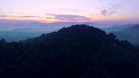 Aerial view Drone flying through the fog above mountain peak Beautiful light sunrise or sunset nature Landscape Amazing video cinematic nature view in Thailand on December 15-2021
