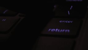 Backlit laptop keyboard. Software engineer working in a dark room, pressing the enter button. Start of the process. Debugging the program code - Powered by Shutterstock - Get 15% off with code: PIKWIZARD15