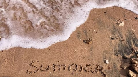 Summer sign on sand sea wave. Summer beach on ocean wave. Seaside holiday. Summer seascape. Ocean wave on sand beach. 