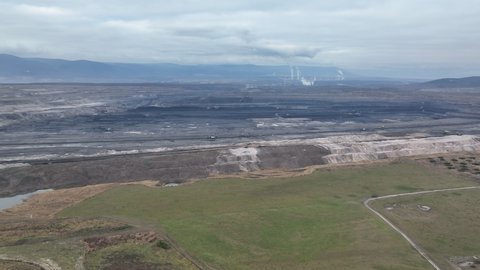 Reclamation of grass brown coal opencast mine bucket wheel excavator giant giant Vrsany, aerial video shot view, open pit lignite heavy quarry, fast-growing birch, alder, poplar and willow trees