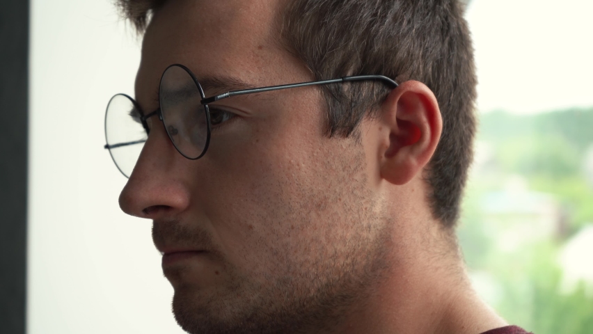 man in glasses works at the computer and smiles Royalty-Free Stock Footage #1084089496