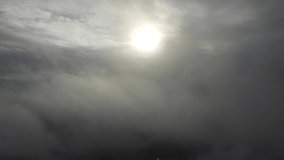 4K video flying over the clouds. The sun between the clouds.