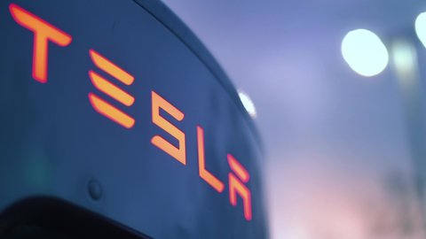 LOS ANGELES - December 2021: TESLA logo closeup shot on super charger electric car charging station 