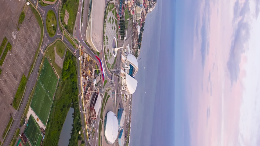 Vertical video. Sochi, Russia - September 5, 2021: Sochi Park. Day-night transition. Turn on night illumination. Bowl of the Olympic flame, Fisht Arena, Sochi Autodrom track and more, Aerial View Hyp
