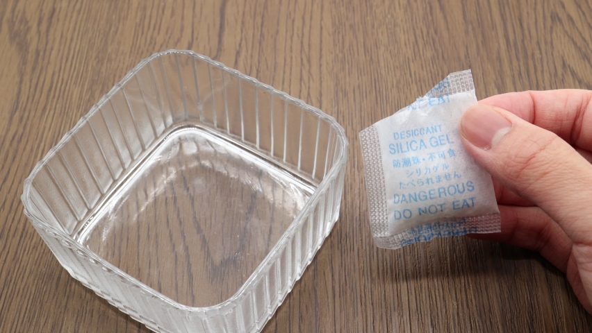 A desiccant made mainly from silica gel. Translation: Desiccant. Don't eat. Silica gel. Royalty-Free Stock Footage #1084101814