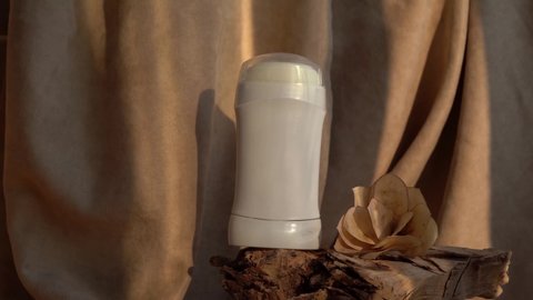White antiperspirant deodorant staying on wood . Skin care concept