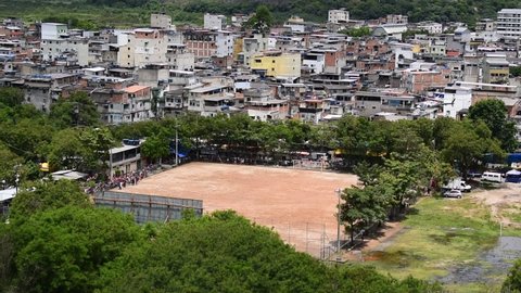 Helicopter landing on soccer field in favela. Arrival of Santa Claus for give gifts to the children.