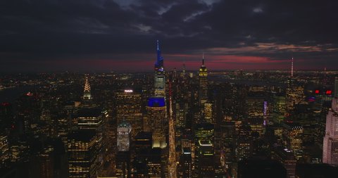 Breath taking panoramic footage of evening downtown. Backwards reveal of illuminated skyscrapers. Manhattan, New York City, USA