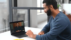 Cheerful Indian male colleagues greeting each other during virtual meeting, ethnic guy using computer app for video connection with employee, friend or tutor on the distance